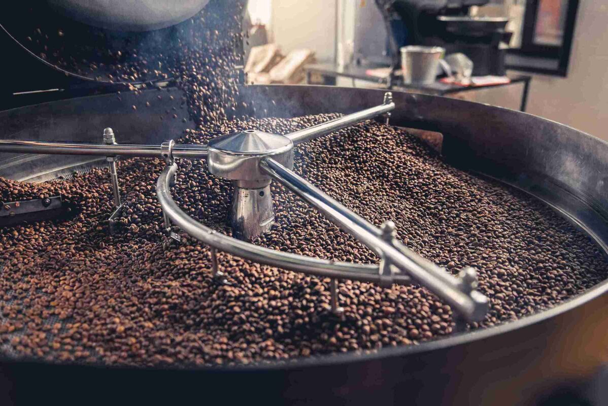 Lugano Caffe Contact us - roasted beans poured out of a roasting machine