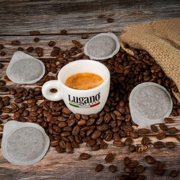 Espresso Pod with Lugano Cup among coffee beans